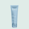 Tube de crème en plastique bleu Thalgo avec bouchon en plastique bleu, sur fond vert